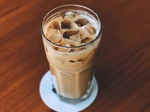 Glass full of iced, creamy coffee drink.