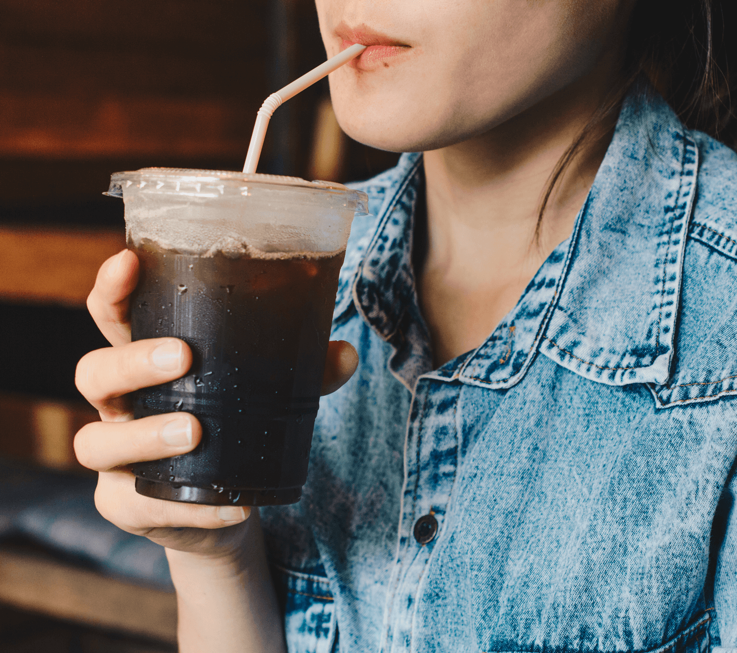 a woman enjoying a refreshing beverage through a straw